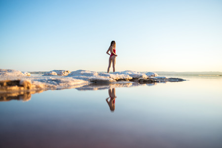 Young girl in red swimsuit at the beachの写真素材