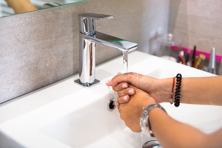 Girl washing her hands in the toilet