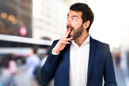 Handsome man making surprise gesture on unfocused backgroundの写真素材