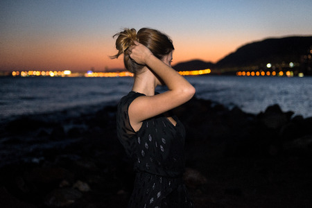 Young girl on the beach at sunsetの写真素材