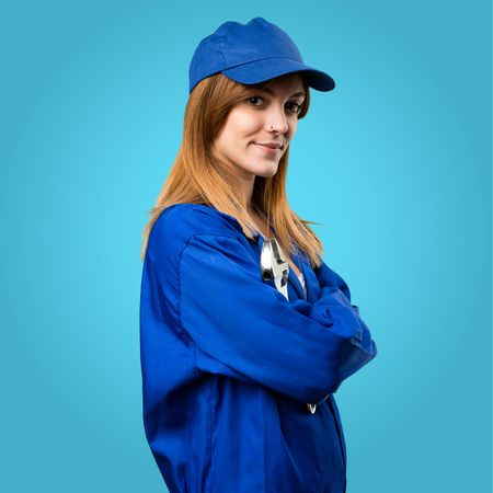 Delivery woman with her arms crossed on colorful backgroundの写真素材