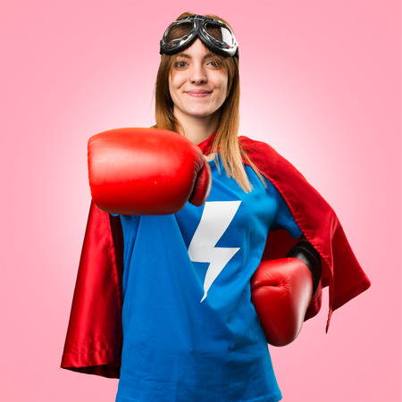 Superhero girl with boxing gloves on colorful backgroundの写真素材