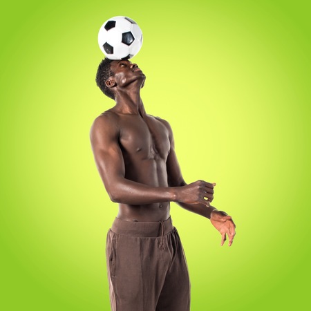 Black man playing footballの写真素材