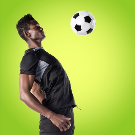 Black man playing footballの写真素材