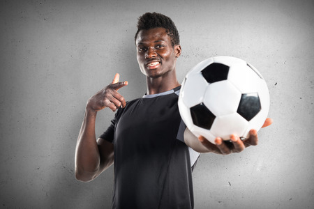 Black man playing football on textured backgroundの写真素材