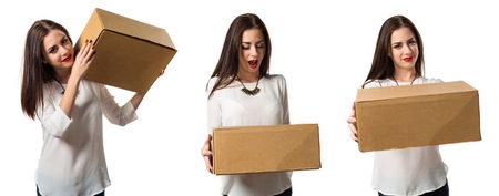 Pretty young girl holding boxesの写真素材