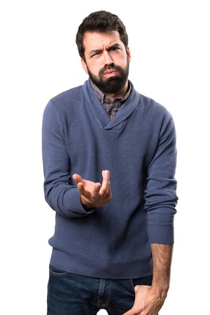 Tired handsome brunette man with beard on white backgroundの写真素材