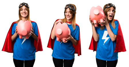 Pretty superhero girl holding a piggybankの写真素材