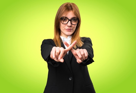 Young business woman making NO gesture on colorful backgroundの写真素材