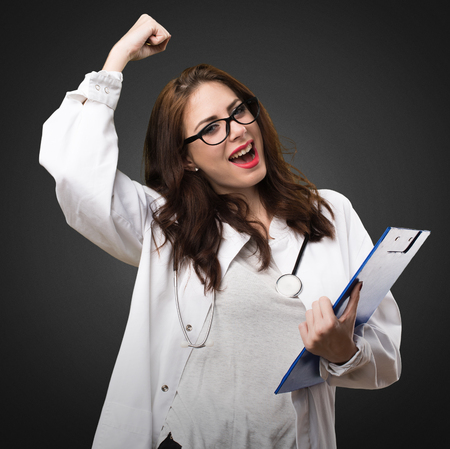 Doctor woman holding a folder on black backgroundの写真素材