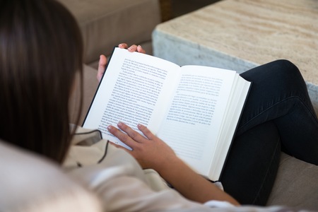 Beautiful young girl reading bookの写真素材