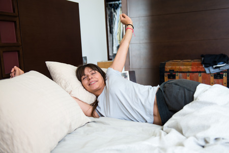 Beautiful young girl yawningの写真素材