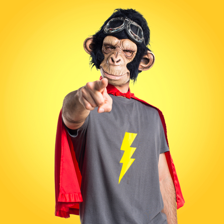 Superhero monkey man pointing to the frontの写真素材