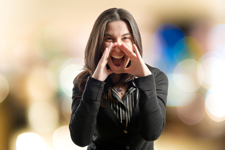 Adult girl shouting over isolated white background の写真素材
