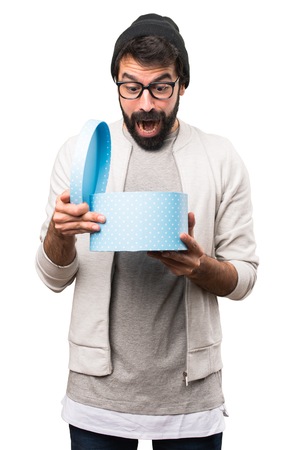 Hipster man holding a gift on white background