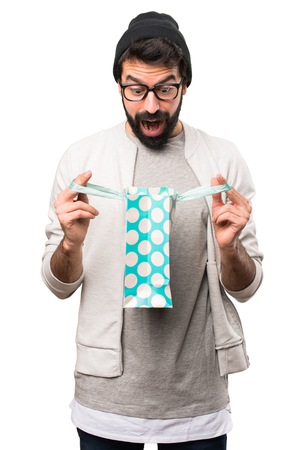 Surprised Hipster man with shopping bag on white backgroundの写真素材
