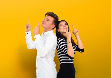 Young couple pointing with the index finger a great idea