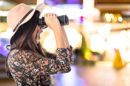 Surprised woman with binoculars 
