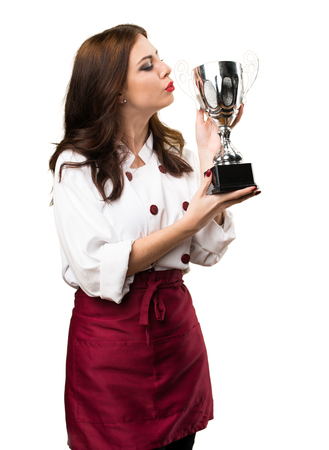 Beautiful chef woman holding a trophyの写真素材