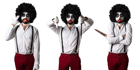 Killer clown with knife making bad signalの写真素材