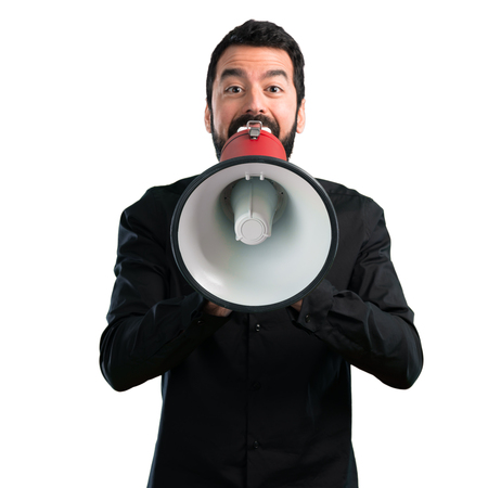 Handsome man with beard holding a megaphone on white backgroundの写真素材