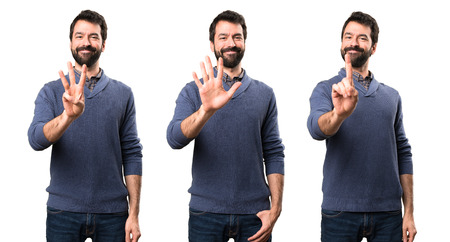 Set of Handsome brunette man with beard counting five, three and oneの写真素材