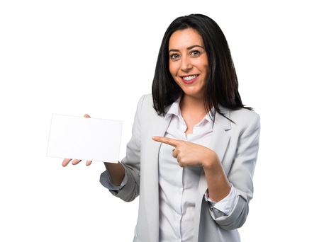 Pretty woman holding an empty placard on white backgroundの写真素材