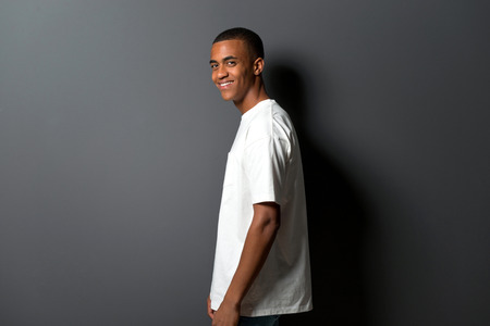 Happy young african american man on grey wall backgroundの写真素材
