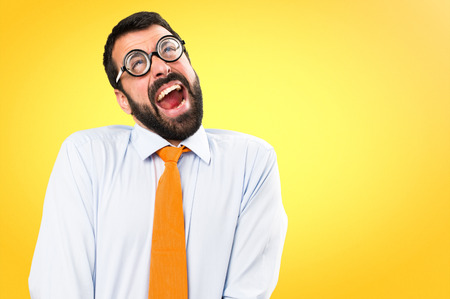 Funny man with glasses shouting on colorful backgroundの写真素材