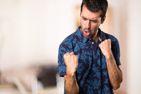 Lucky brunette man inside roomの写真素材