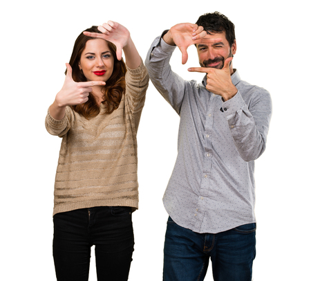 Young couple focusing with their fingersの写真素材