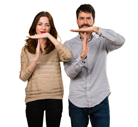 Young couple making time out gestureの写真素材