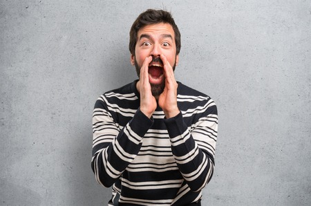 Man with beard shouting on textured backgroundの写真素材