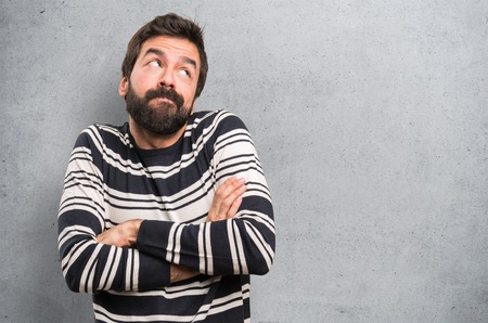 Man with beard making unimportant gesture on textured backgroundの写真素材