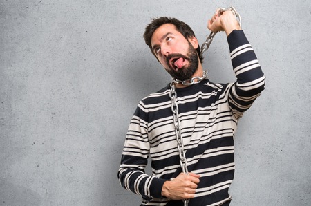 Man with beard with chains on textured backgroundの写真素材