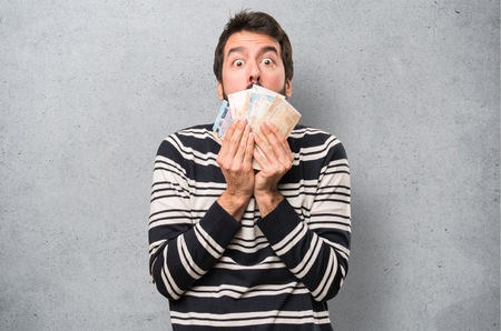 Man with beard taking a lot of money on textured backgroundの写真素材