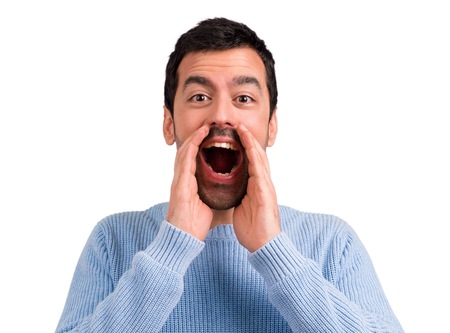 Handsome man shouting with mouth wide open