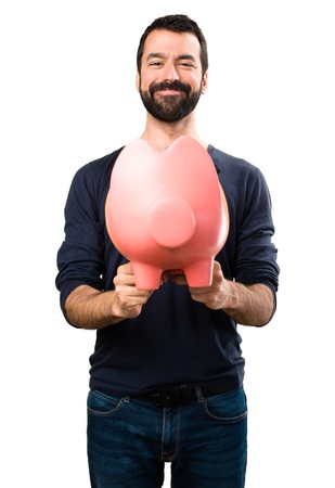 Handsome man with beard holding a piggybankの写真素材