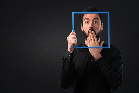 Handsome man with beard with framework on black background