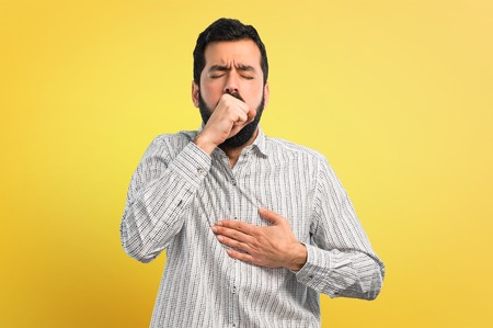 Handsome man with beard is suffering with cough and feeling bad