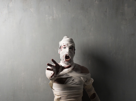 Terrorific mummy screaming on textured wall background.  Halloween holidaysの写真素材