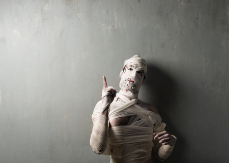 Terrorific mummy on textured wall background.  Halloween holidaysの写真素材