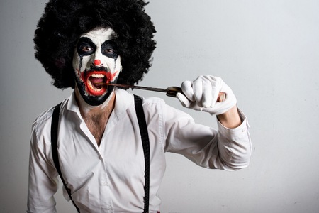 Killer clown with knife on textured backgroundの写真素材