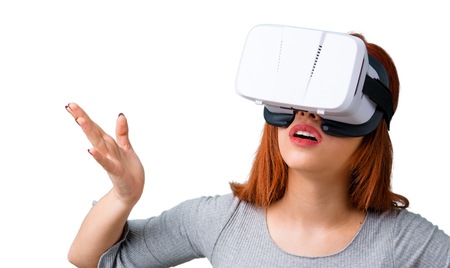 Young redhead girl using VR glasses. Virtual reality experience