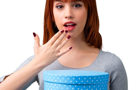 Young redhead girl holding gift boxes in handsの写真素材