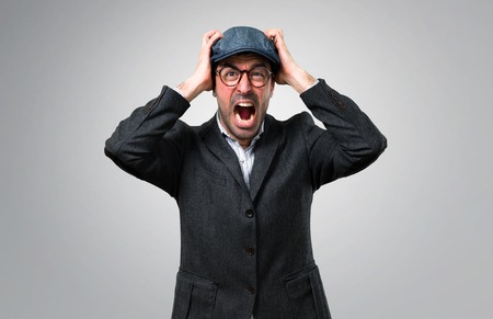 Handsome modern man with beret and glasses unhappy and frustrated with something. Negative facial...