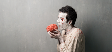 Terrorific zombie eating a brain.  Halloween holidaysの写真素材