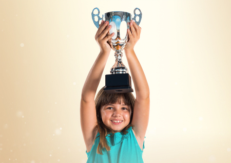 Young girl holding a trophyの写真素材