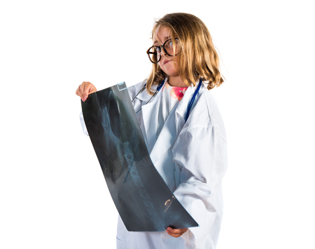 Little girl playing to be a doctor and holding a radiographyの写真素材