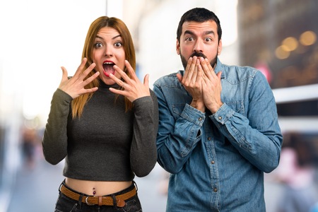 Man and woman making surprise gesture on unfocused backgroundの写真素材